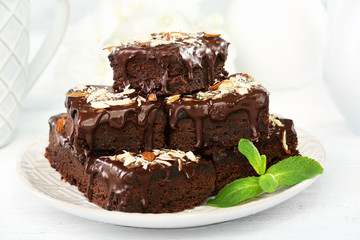 Delicious chocolate cakes on plate on table close-up