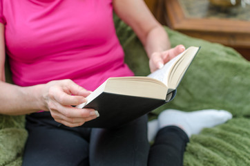 Woman reading a book on a couch