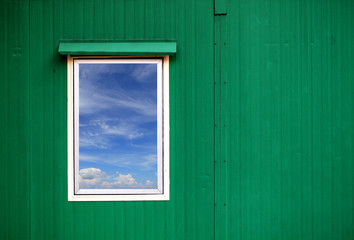 Closed plastic window with blue sky cloud.