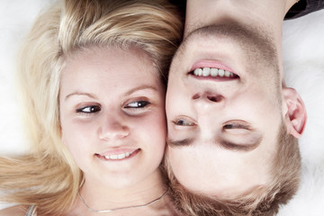 happy young loving couple embracing, white background