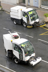 workers with street sweepers  electrical  vehicles cleaning the