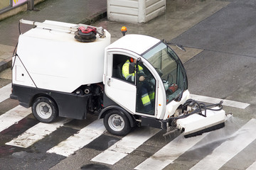 worker with street sweeper lectrical  vehicles cleaning