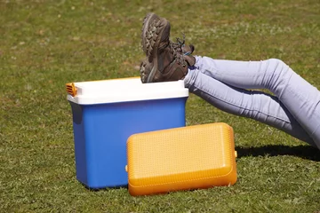 Printed kitchen splashbacks Picnic Picnic cooler in the grass and trekking boots in Spain