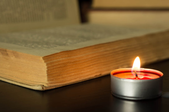 Small candle near the open book