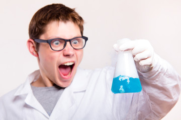 Surprised chemist in laboratory holding test tube during the rea