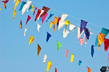 colorful bunting flags on blue sky