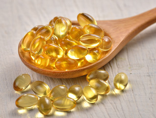 Fish oil capsules in a spoon