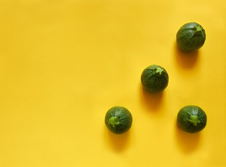 Round zucchini triangle on yellow background
