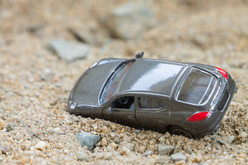 Toy car on a sand background