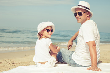 Father and daughter playing on the beach.