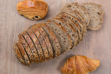Brown slices of bread isolated over wooden brown  background