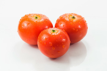 Three tomatoes isolated on white background
