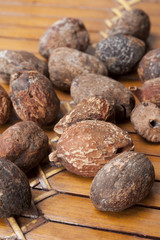 shea nuts near butter on white background