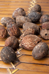 shea nuts near butter on white background