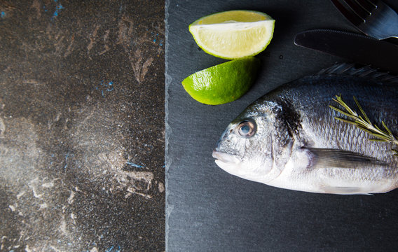 Fresh fish and lime on a plate