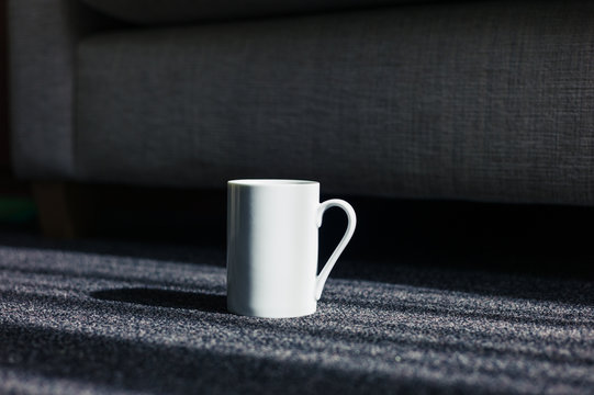 White mug on carpet at home