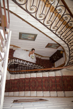 A bride descends a staircase to see her groom