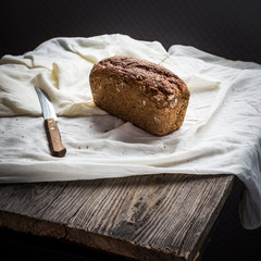 Assorted bread, slices of rye bread on linen tablecloths, wooden