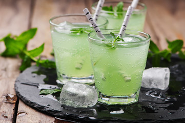Green cocktail witn rum and mint