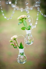 Wedding decor with wedding rings and roses in bulbs