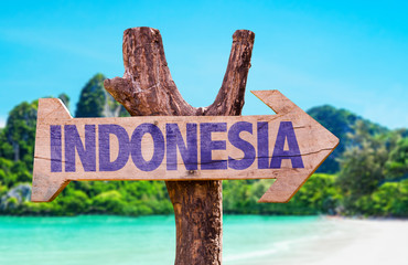 Indonesia wooden sign with beach background