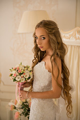 charming beautiful bride holding wedding bouquet in her hands