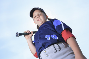 A Baseball girl hitter over a blue sky