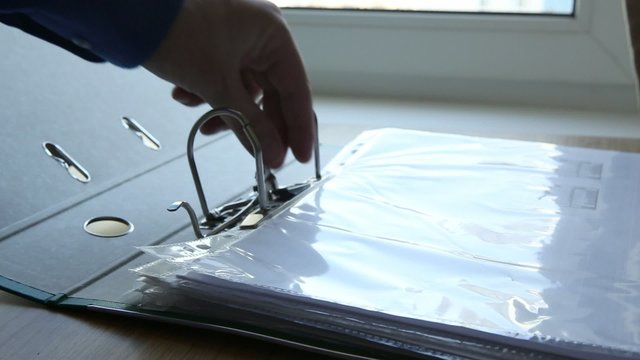 Opening an office document holder and putting a document in it