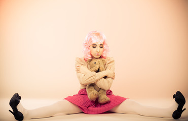 childlike woman with teddy bear toy