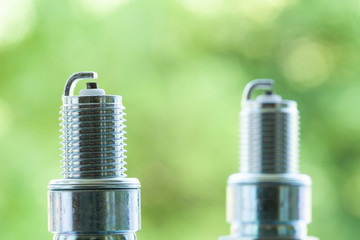 Auto service. Two new spark plugs as spare part of car.