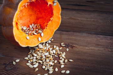 pumpkin and seeds on wood background