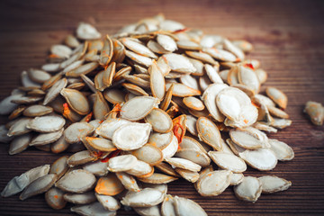 pumpkin seeds on wood background