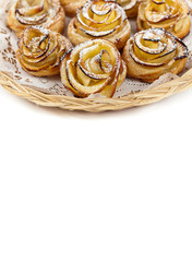 Puff pastry with apple shaped roses on white background
