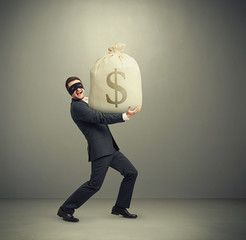 man holding big bag with money