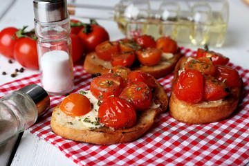 Slices of white toasted bread with butter and canned tomatoes