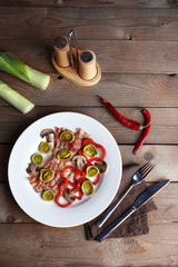 Strips of bacon with sliced shallot and pepper in plate