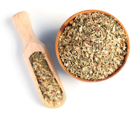 Dried parsley in wooden bowl, isolated on white
