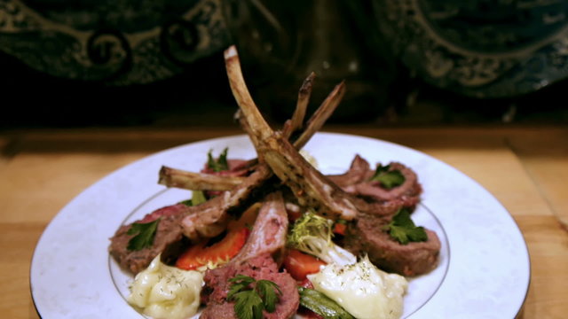 Lamb Chop Dish Dolly Down with Strawberries and Leafy Greens.