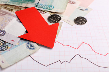 Money and red arrow on graph document close up
