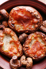 Baked potatoes with mushrooms in bowl close up
