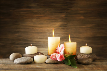 Fototapeta na wymiar Beautiful composition with candles and spa stones