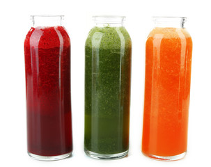 Assortment of healthy fresh juices in glass bottles, isolated