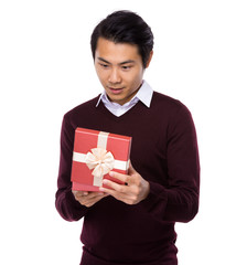 Asian young man open with present box