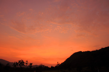 Orange sky after sunset with mountain