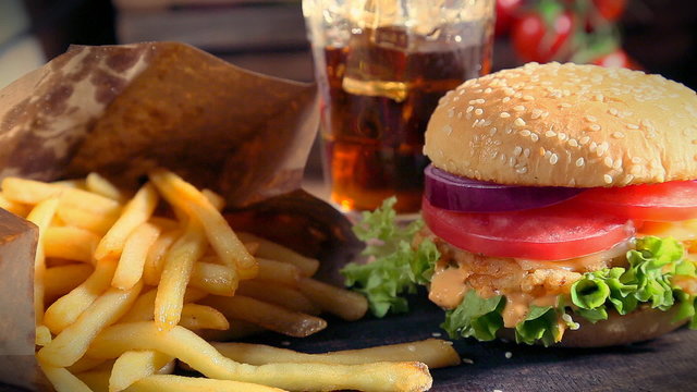 Fresh takeaway hamburger with cold drink and fries