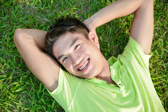 Young Man Lying On The Grass