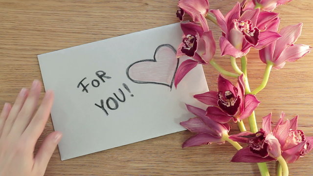 For you note card and flowers on wooden board, top view