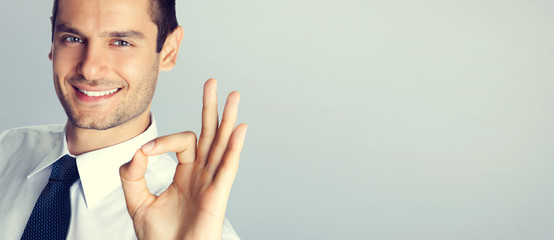 Young businessman with okay gesture