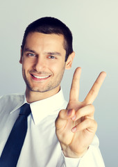 Young businessman showing two fingers