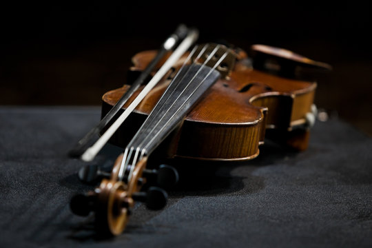 Violin lying in dark colors